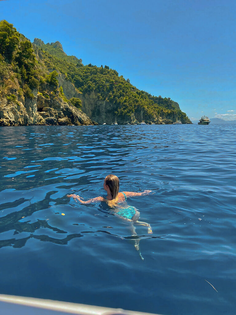 Pinterest style photo of girl swimming in the ocean on the Amalfi Coast