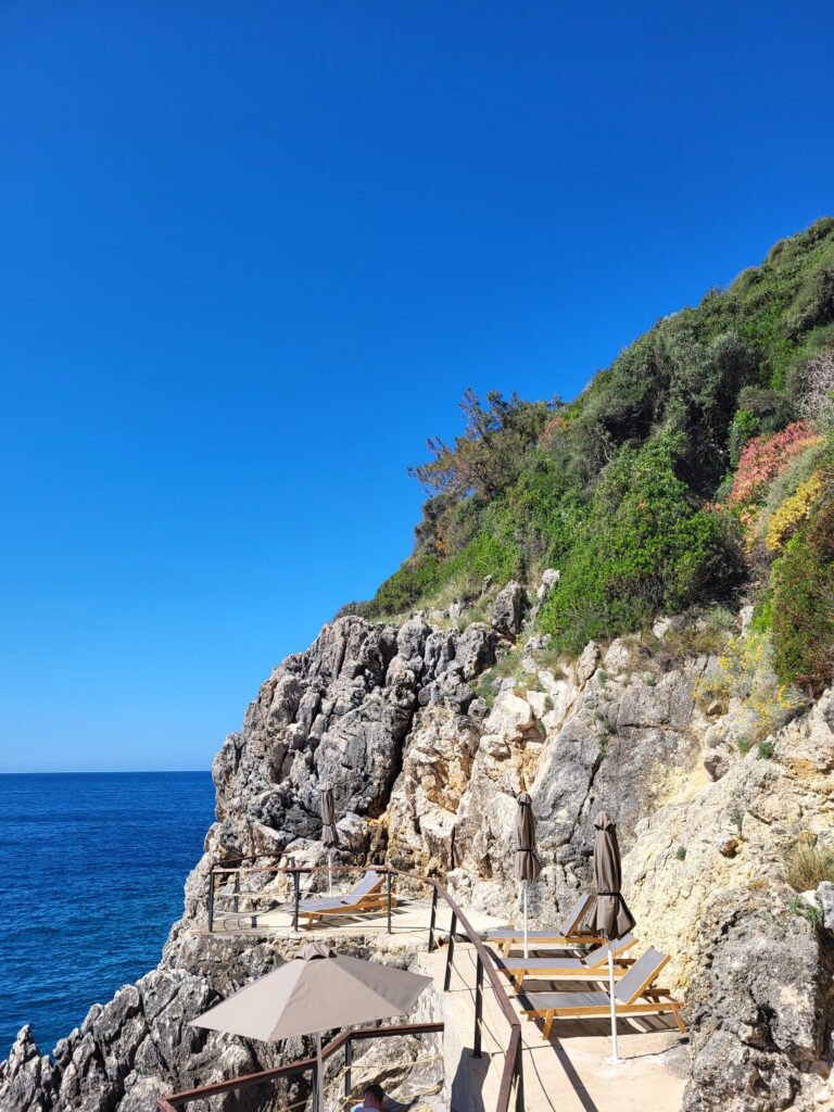 Sunbeds on the Rocky Beach at The Akrotiri Beach Resort Hotel